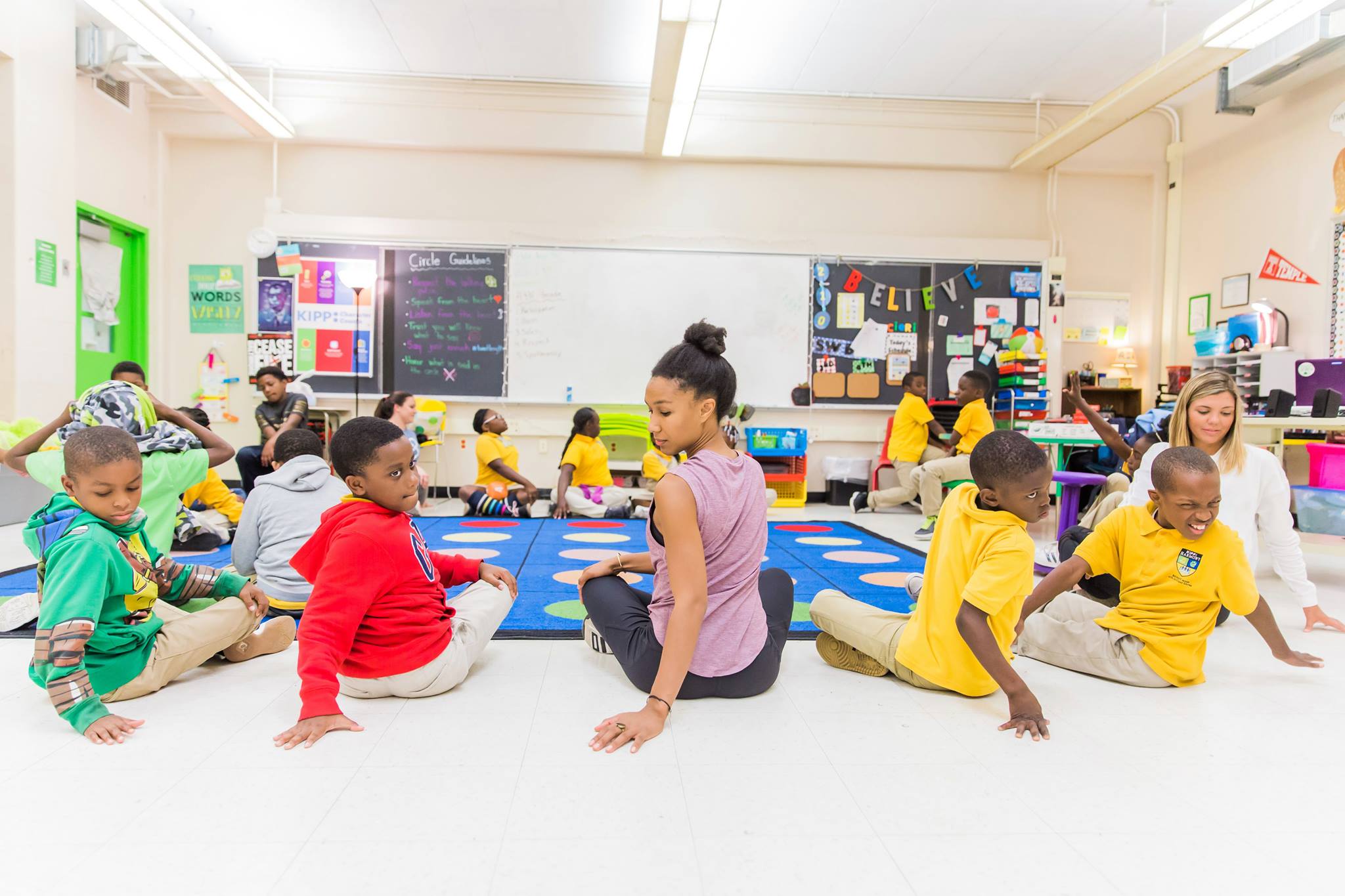 Nicole sitting in a circle with students in a classroom